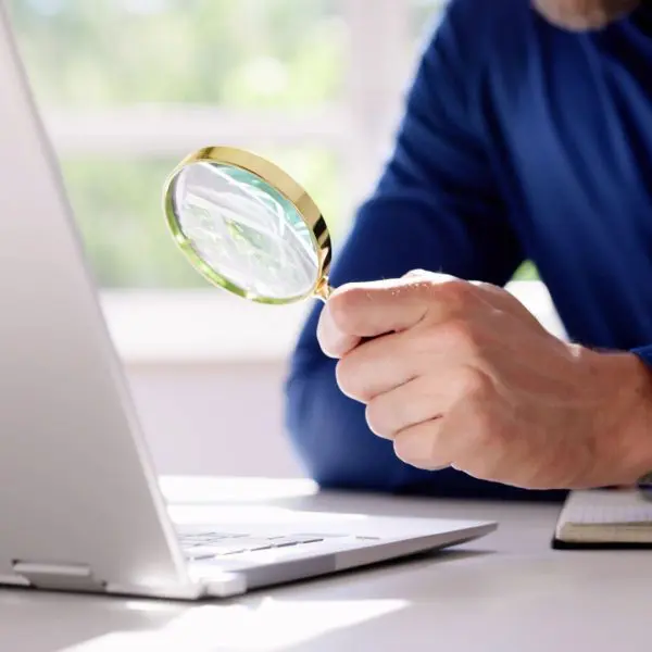 homme qui tient une loupe dans sa main