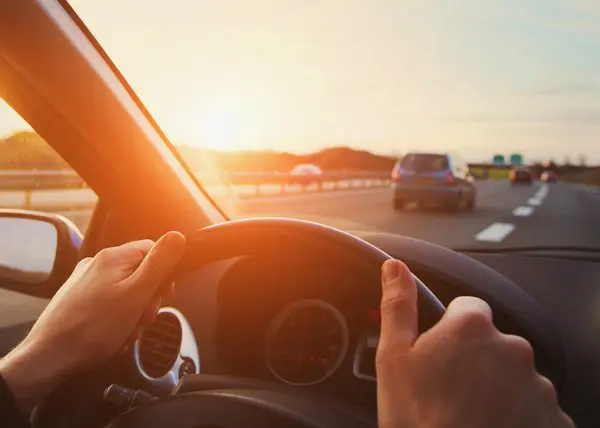 Mains du conducteur sur le volant, voyage sur la route